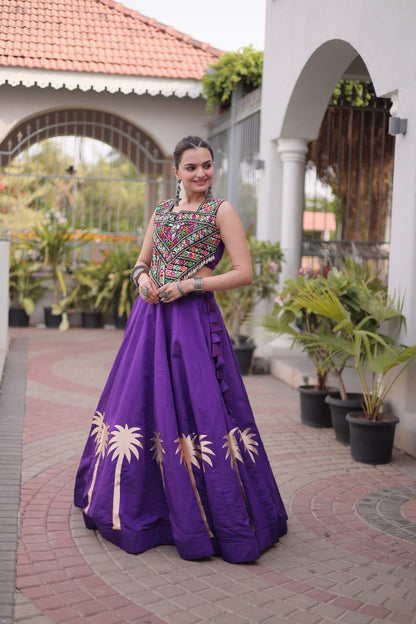 Purple Kutchi Gamthi embroidered lehenga choli with gold coconut gota work, three-quarter front view with side ruffle detailing
