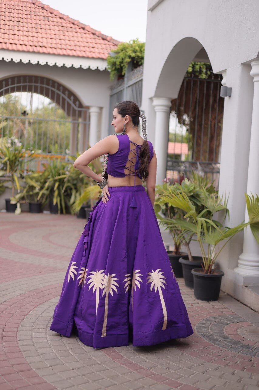 Purple lehenga choli with sleeveless lace-up back blouse and gold coconut-inspired gota work, rear three-quarter view