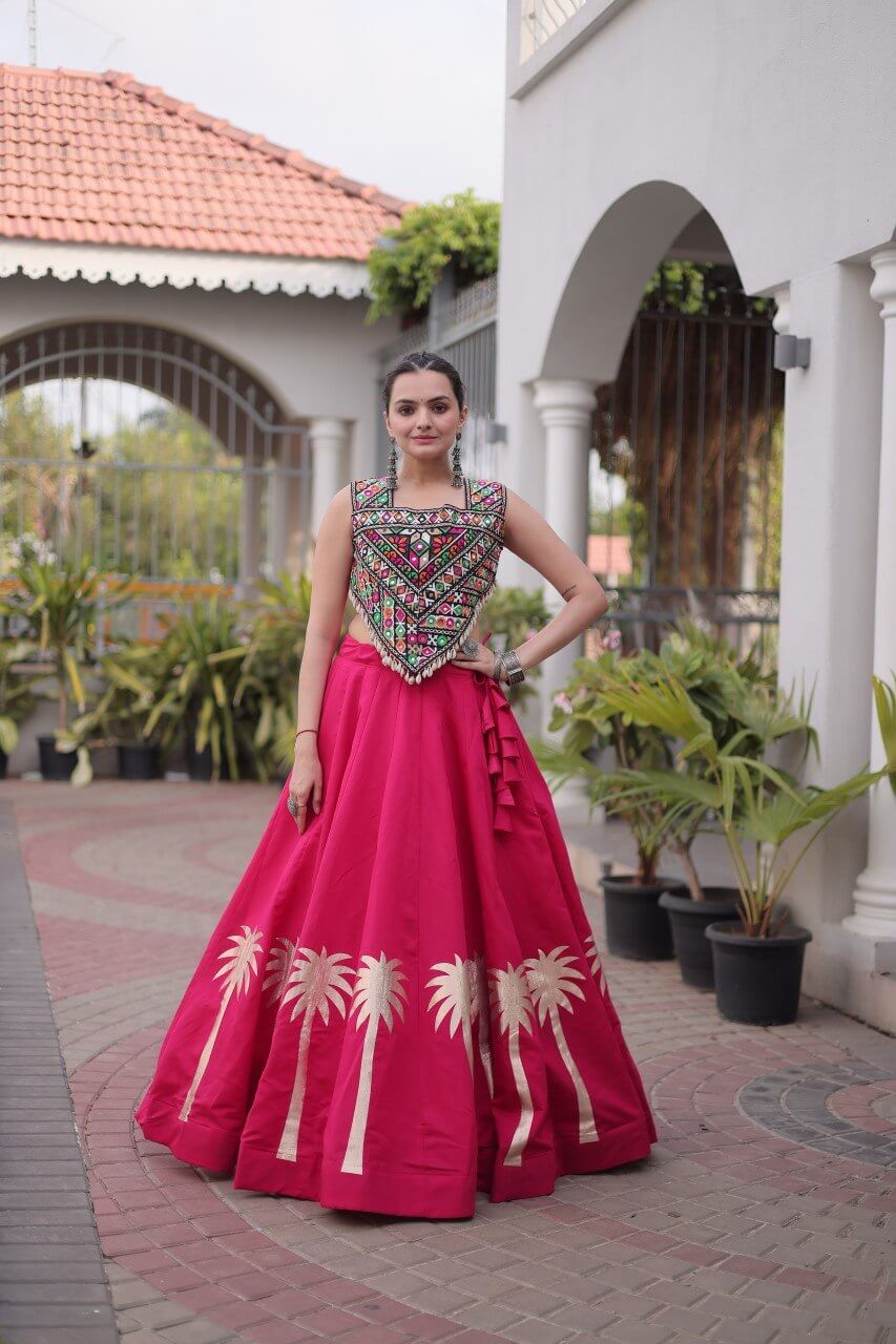 Front view of magenta pink lehenga choli with sleeveless embroidered blouse and gold Coconut Gota hem detailing