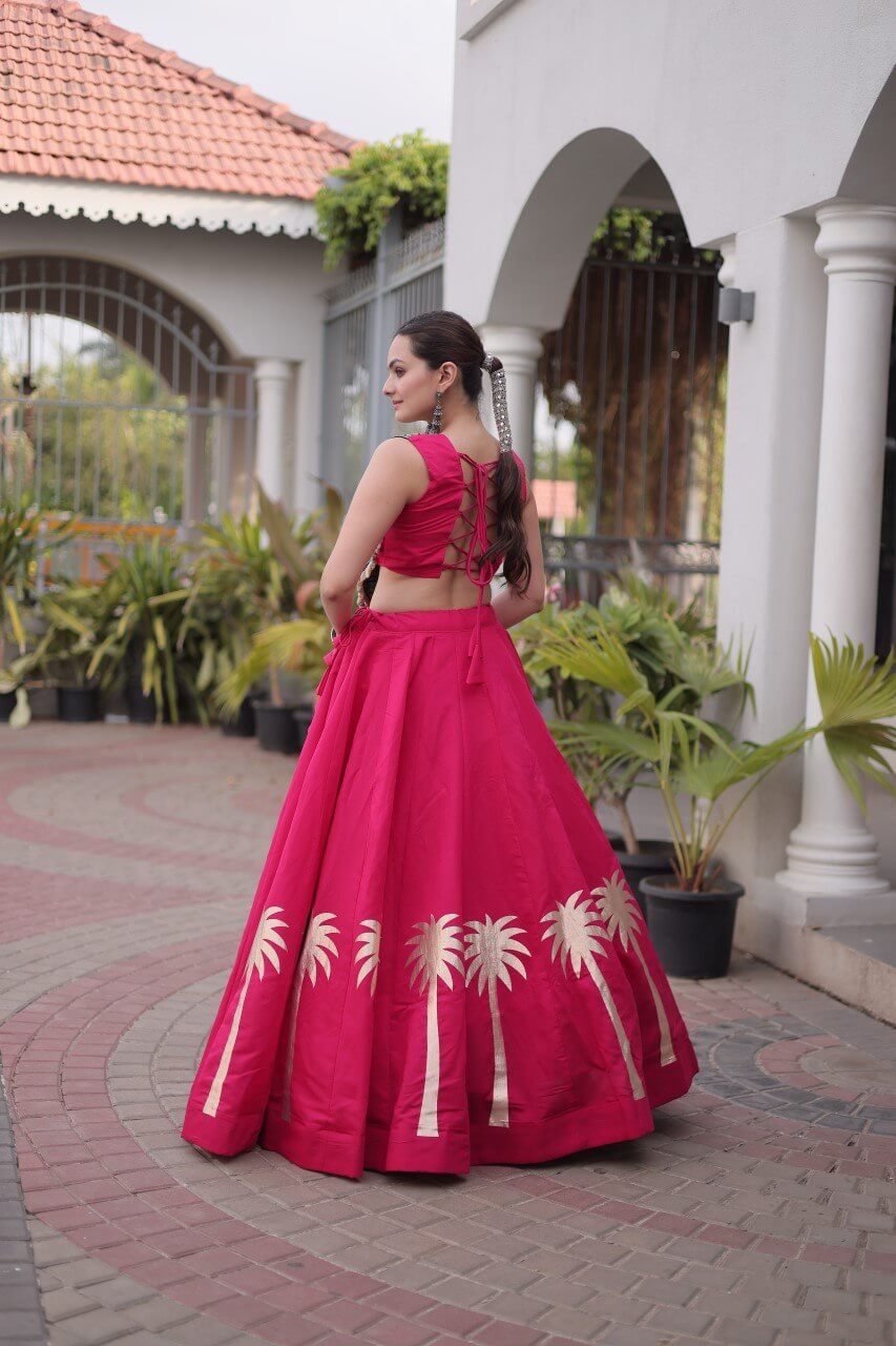 Back view of magenta pink lehenga choli with lace-up dori blouse and gold Coconut Gota hem detailing