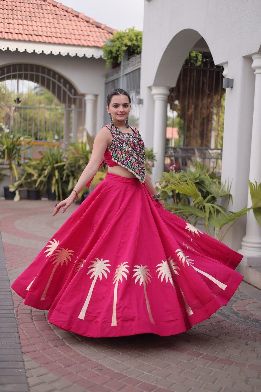 Magenta pink flared lehenga choli with colorful Kutchi Gamthi embroidered blouse and gold Coconut Gota motifs