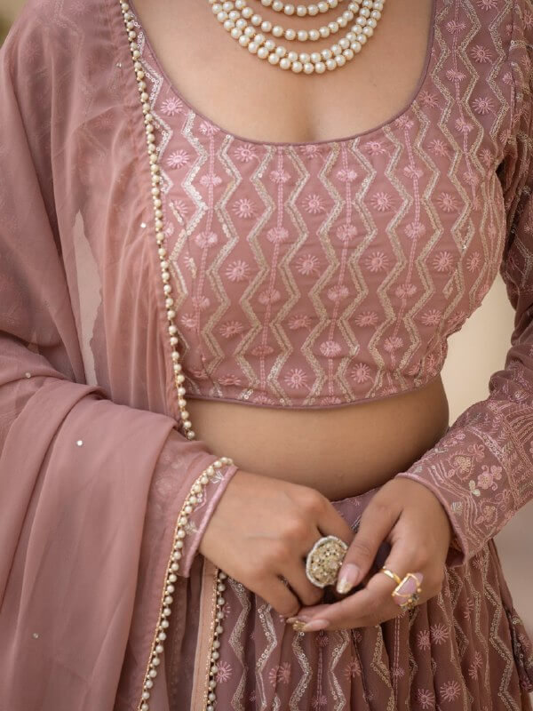 Close-up of rosy brown blouse with geometric thread, zari and sequin embroidery
