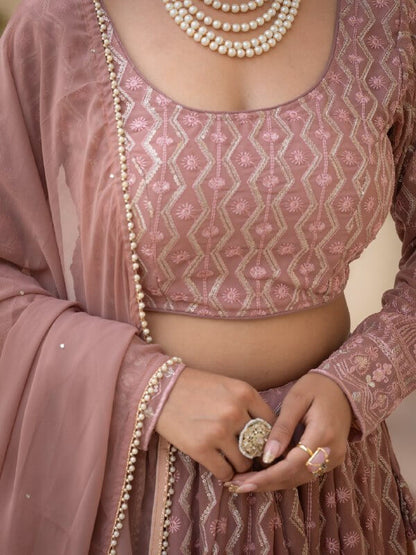 Close-up of rosy brown blouse with geometric thread, zari and sequin embroidery