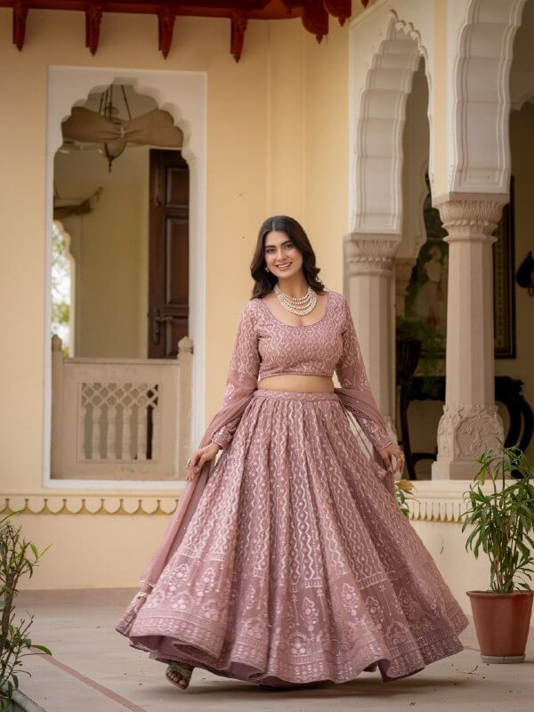 Rosy brown embroidered lehenga shown in motion with geometric pattern and ornate hem border