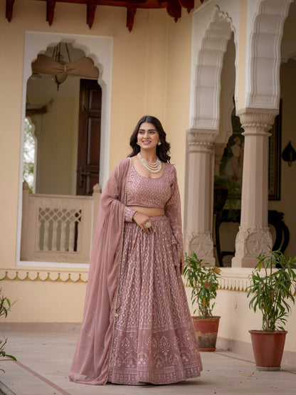 Rosy brown embroidered lehenga shown in motion with geometric pattern and ornate hem border