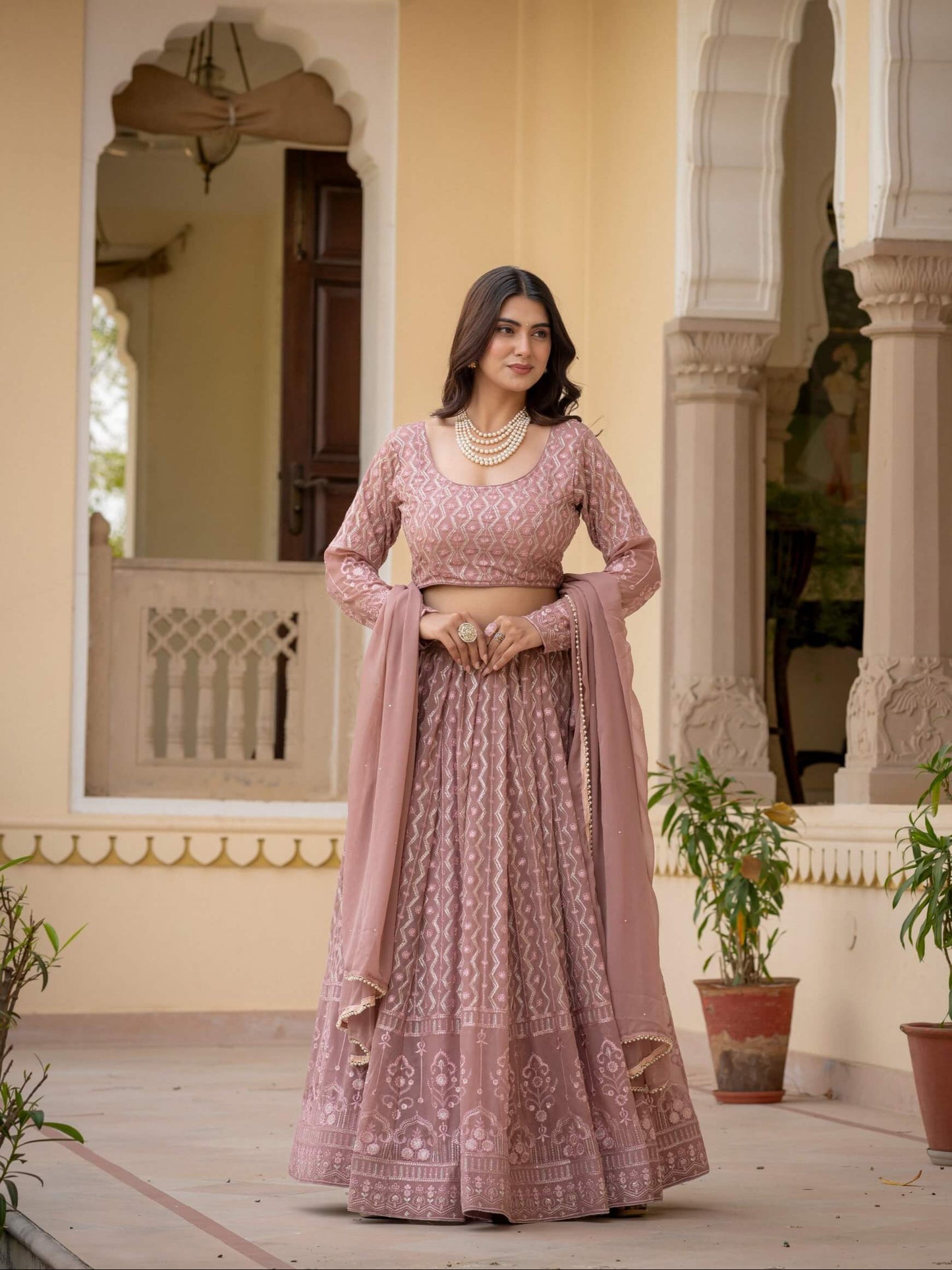Rosy brown lehenga choli featuring long sleeve embroidered blouse and matching dupatta