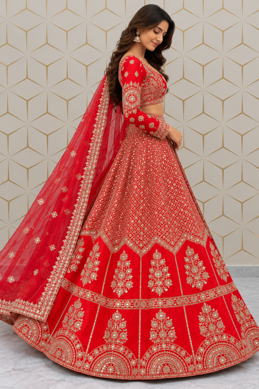 Side profile full-length view showing the flared circular silhouette and scalloped hemline of a red bridal lehenga with sheer embroidered net dupatta.