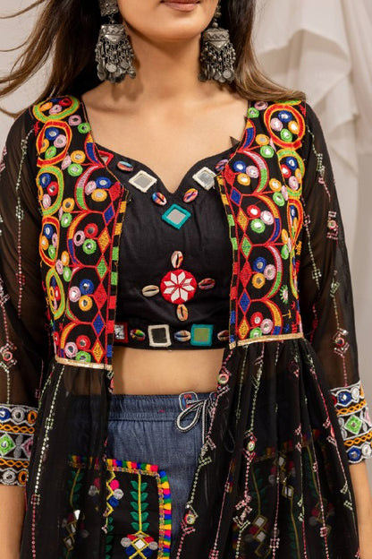 Close-up detail of black sweetheart neck crop top and shrug bodice adorned with cowrie shells and vibrant mirror embroidery