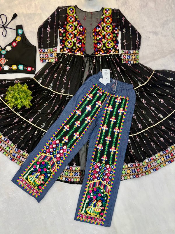 Flat lay view of black tiered shrug with mirror embroidery, black crop top, and blue denim pants with embroidered panels