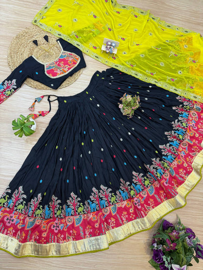 Flat lay view of black flared lehenga with animal-tree border, matching full-sleeve blouse with pink embroidered yoke, and bright yellow dupatta