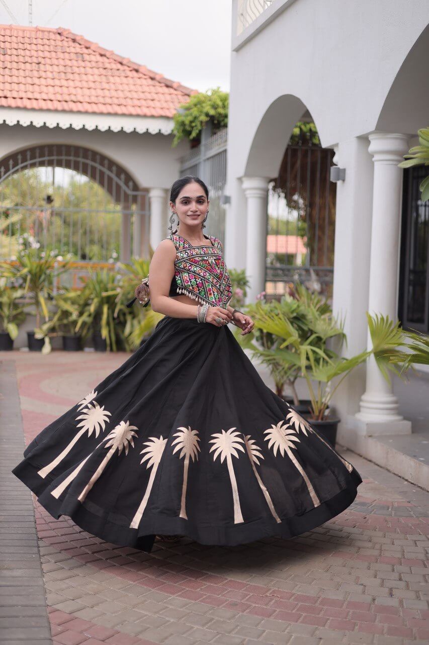Three-quarter view of a black lehenga choli with a multicolor patterned blouse and beige floral skirt motifs