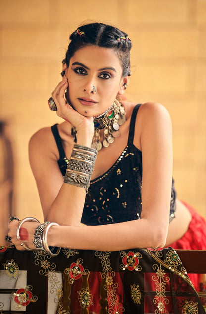 Close-up portrait of model wearing a black sleeveless sequined crop blouse styled with heavy oxidized tribal silver jewellery