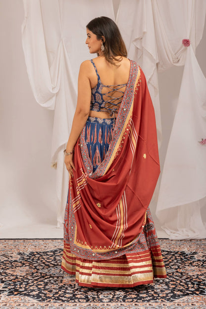 Back view of model wearing printed blue choli blouse featuring criss-cross back tie-up strings