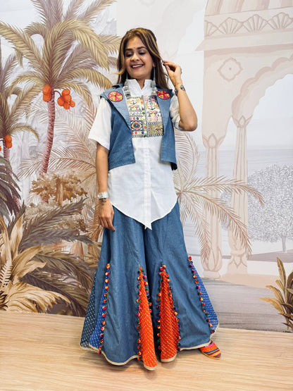 Full-length standing pose of model in a white pointed-hem shirt, blue short jacket, and wide-leg sharara pants