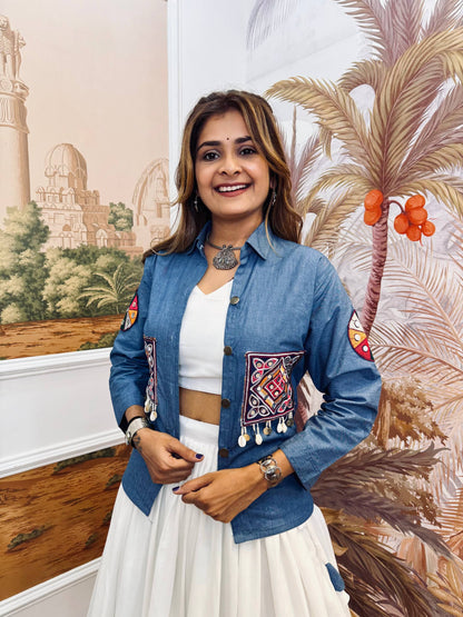 Mid-shot view highlighting the blue shirt-style jacket with colorful pocket embroidery and shell-coin latkan drops