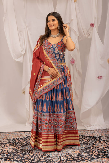 Full-length front view of model wearing blue printed lehenga choli set with draped maroon dupatta