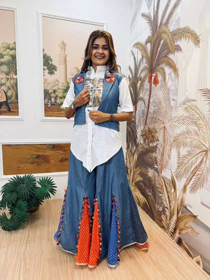 Model wearing a white flared ruffle lehenga and white crop top styled with an open blue embroidered jacket