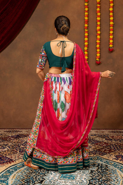 Back view of model wearing dark green blouse with tie-up dori and draped pink mirror work dupatta