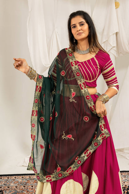 Three-quarter front view highlighting a dark green embroidered dupatta draped over a magenta lehenga choli set.