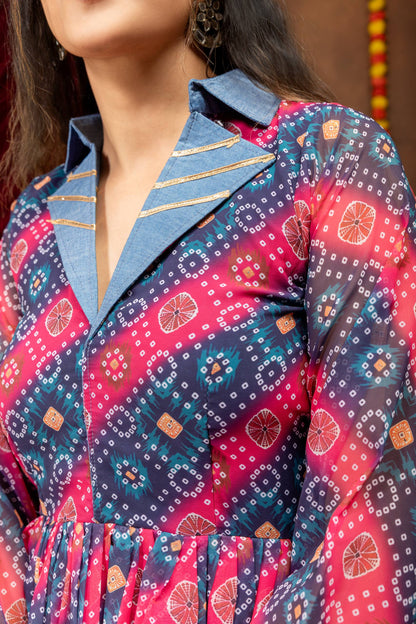 Close-up view of light blue denim notch lapel collar with gold gota lines on a pink and navy bandhani printed top