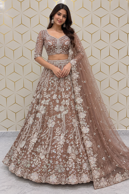 Standing full-length front view of a model wearing a heavily embellished dusty mauve and silver threadwork lehenga choli set.