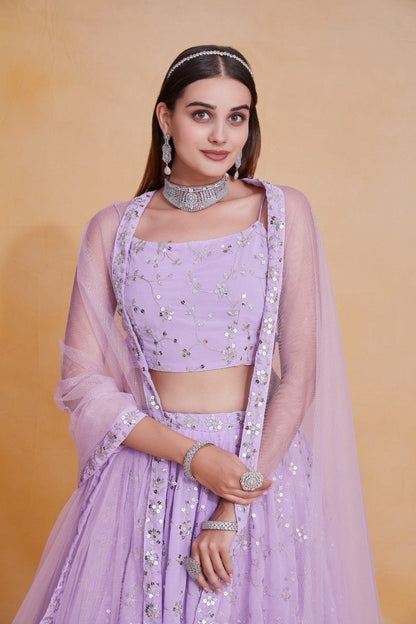 Mid-shot view of a model in a sleeveless lavender choli with sequin accents and a draped dupatta.