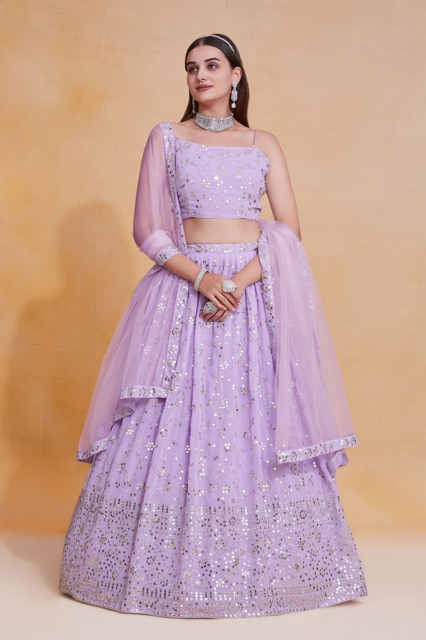 Full-length front view of a model wearing a lavender sequin embroidered lehenga set with a draped net dupatta.