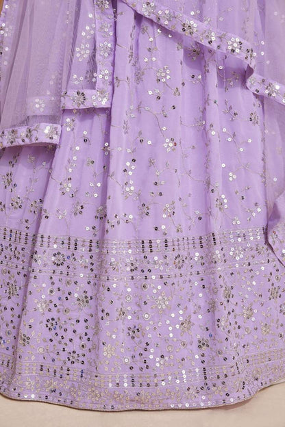 Close-up view of the lavender lehenga skirt showing detailed sequin floral vines and dense hemline border embroidery.