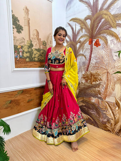 Full-length front shot of model in a gathered magenta pink lehenga skirt with multi-color printed hem and yellow dupatta