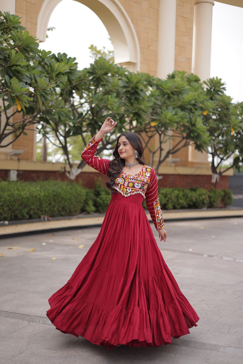 Outdoor full-length shot of model showcasing the flare of a maroon anarkali gown with embellished yoke and sleeves