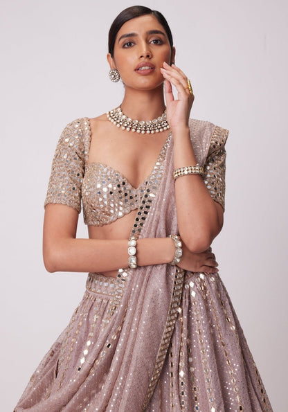 Mid-shot view highlighting the scalloped sweetheart neckline and dense mirror-work embellishment on a mauve-pink half-sleeve blouse