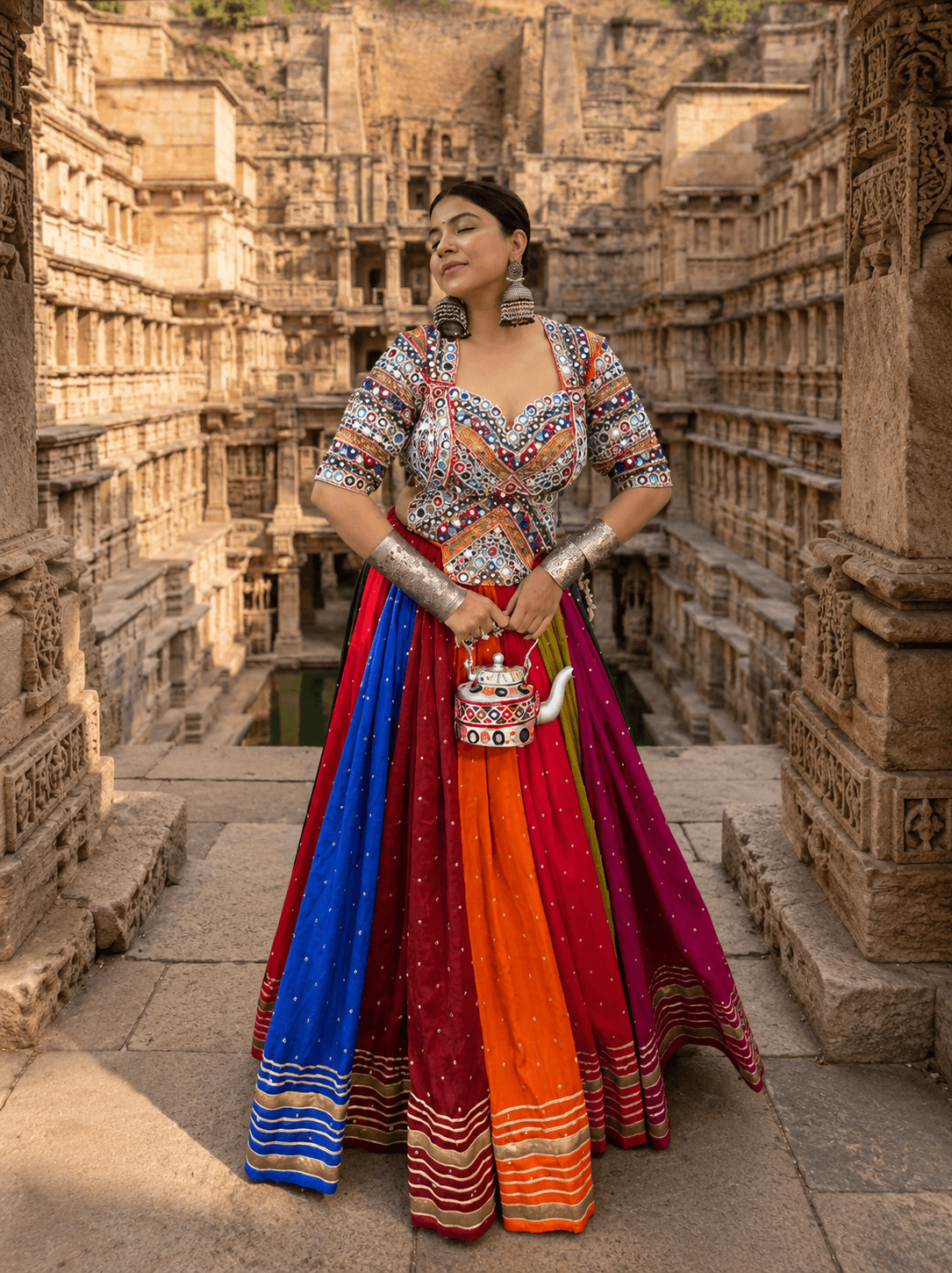 Front standing view of model wearing a multicolor panelled kali lehenga and sweetheart neck mirror work blouse