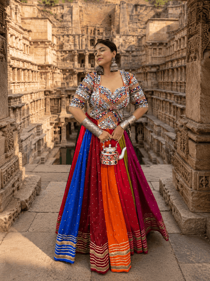 Front standing view of model wearing a multicolor panelled kali lehenga and sweetheart neck mirror work blouse