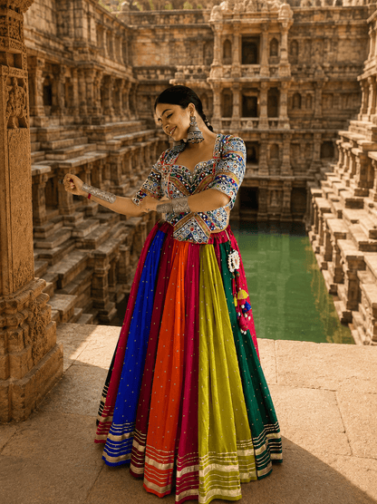 Full-length view of multicolor kali lehenga skirt with gold border stripes, latkan tassel accessory, and mirror work choli