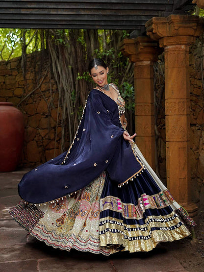 Twirling pose highlighting broad flare of navy blue and cream panelled lehenga with fringed metallic border