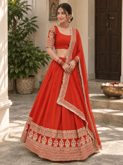 Three-quarter view of orange embroidered chaniya choli set highlighting the hanging fringe dupatta border