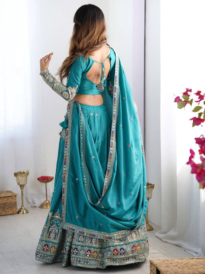 Back view of model wearing peacock blue lehenga choli with tie-up back blouse and embroidered skirt