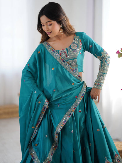 Medium front view of model wearing peacock blue embroidered choli blouse with matching bordered dupatta
