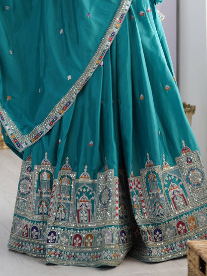 Close-up of peacock blue pleated lehenga skirt hem featuring traditional jharokha motif border embroidery