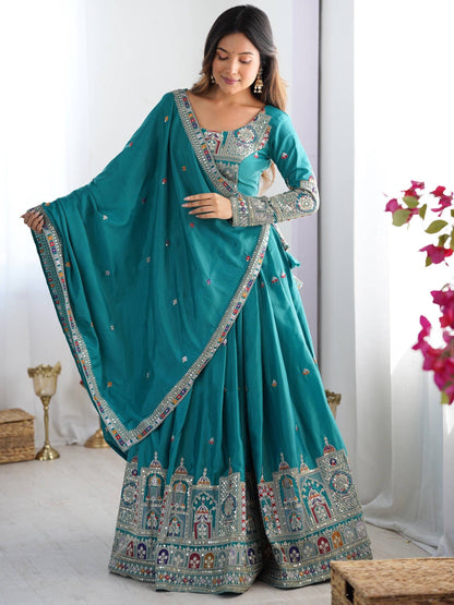Model wearing peacock blue pleated lehenga choli with full-sleeve embroidered blouse and dupatta