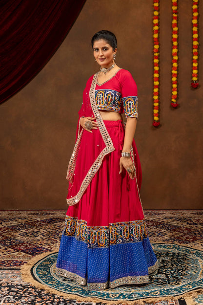 Full-length view of model posing in pink and blue lehenga choli with mirror work border dupatta