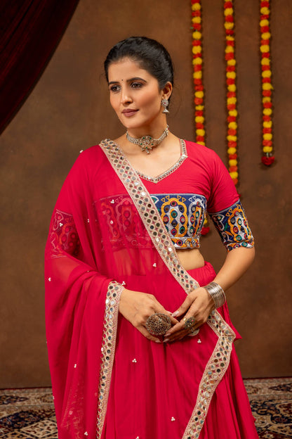 Close-up view of pink embroidered blouse with mirror work detailing and sheer dupatta