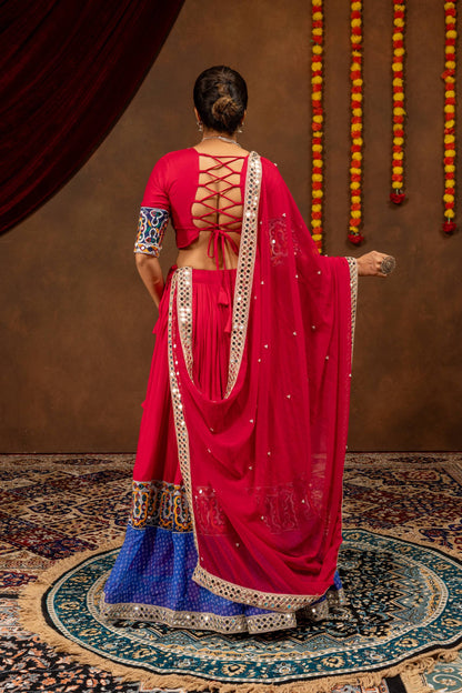 Back view of model wearing pink lehenga choli showing criss-cross tie-up blouse and draped dupatta