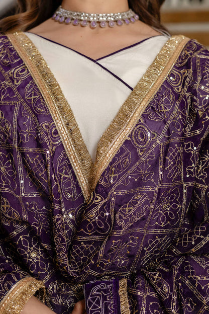 Close-up shot of deep purple dupatta with geometric gold foil patterns and zari fringe border over an off-white angrakha neckline