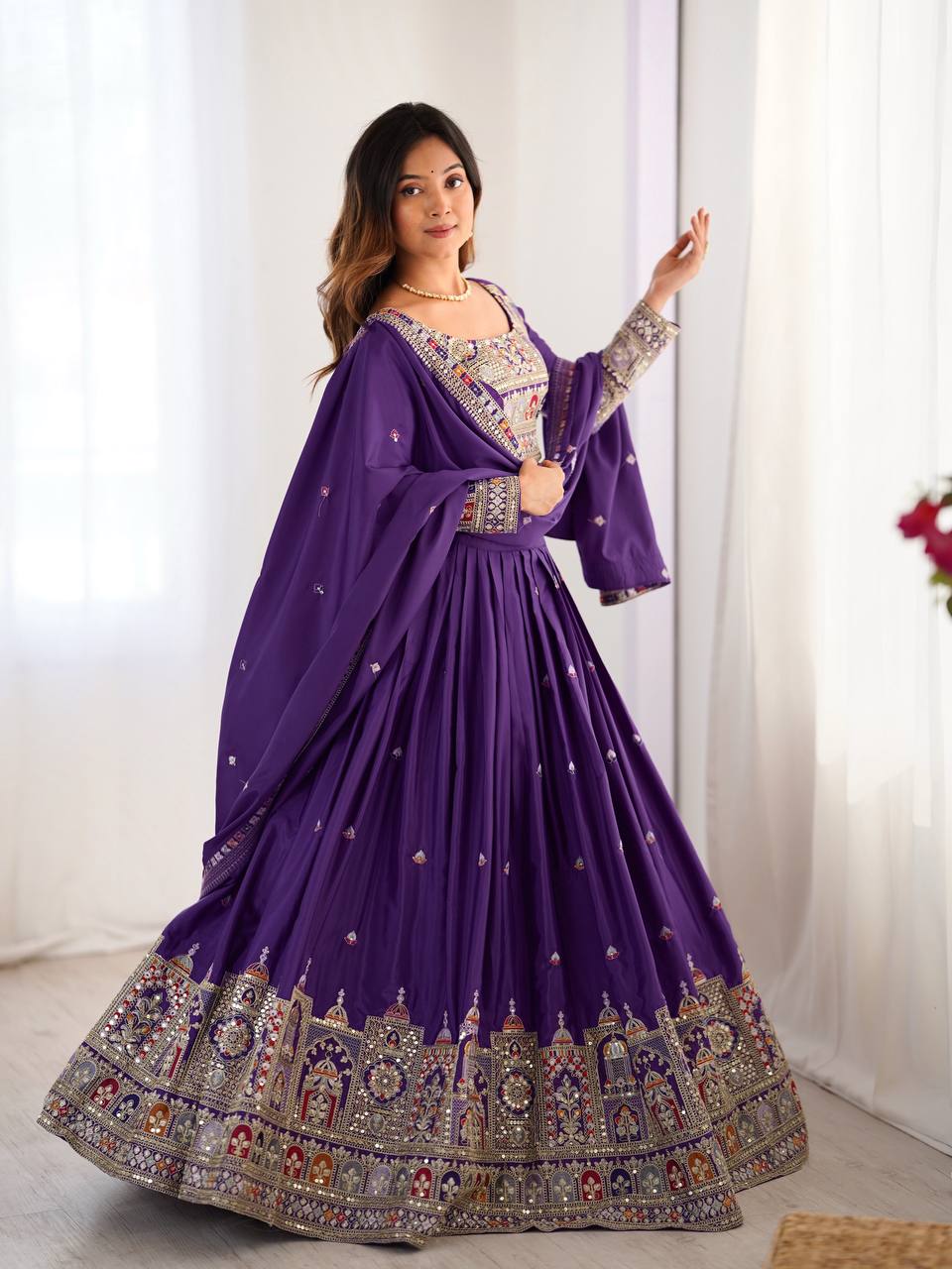 Full-length side-angle shot of purple flared lehenga choli with detailed border embroidery and draped dupatta