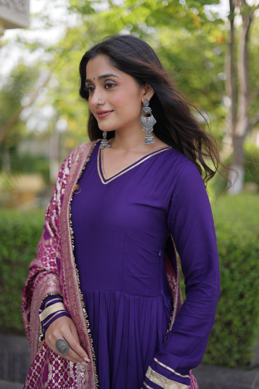 Mid-shot view highlighting the gold piping V-neckline, cuff borders, and woven dupatta pattern on a purple anarkali kurta.