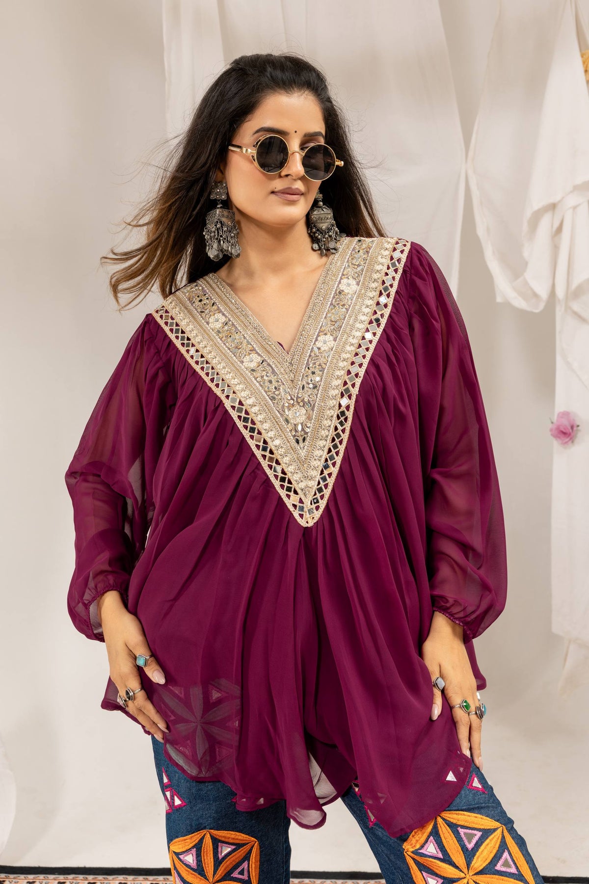 Close-up front view showing detailed neckline embroidery on purple full-sleeve pleated top