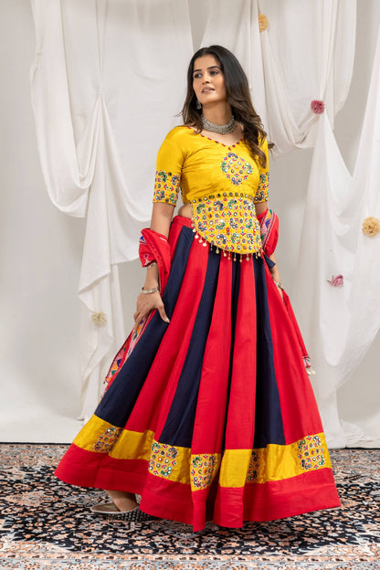 Model in side-angle pose wearing red and navy blue kalidar lehenga skirt with yellow embroidered border and blouse