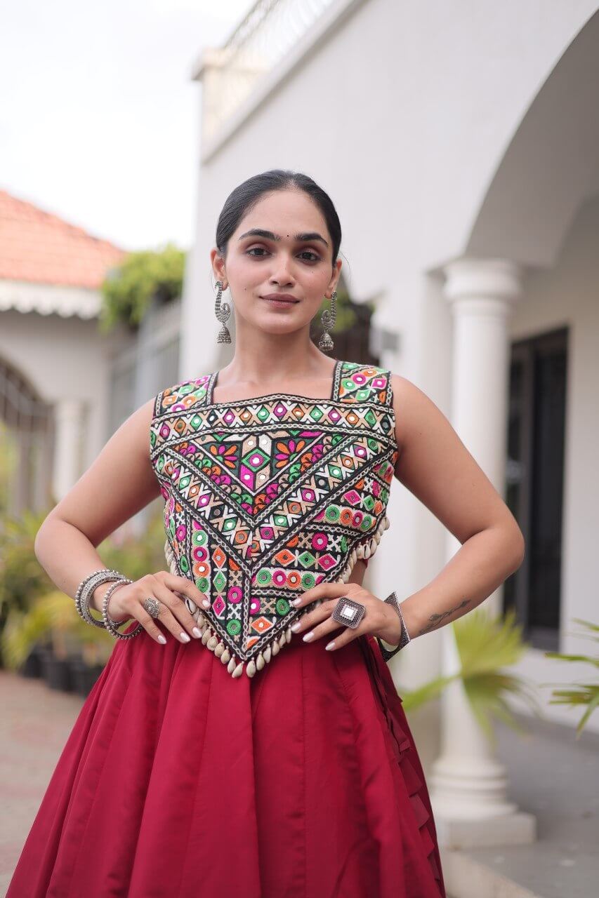Close-up view of the multicolored patterned blouse paired with a red lehenga