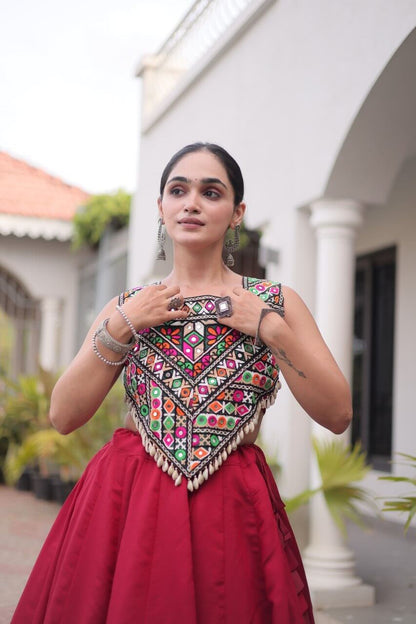 Close-up of the multicolored patterned blouse with cream trim and red lehenga